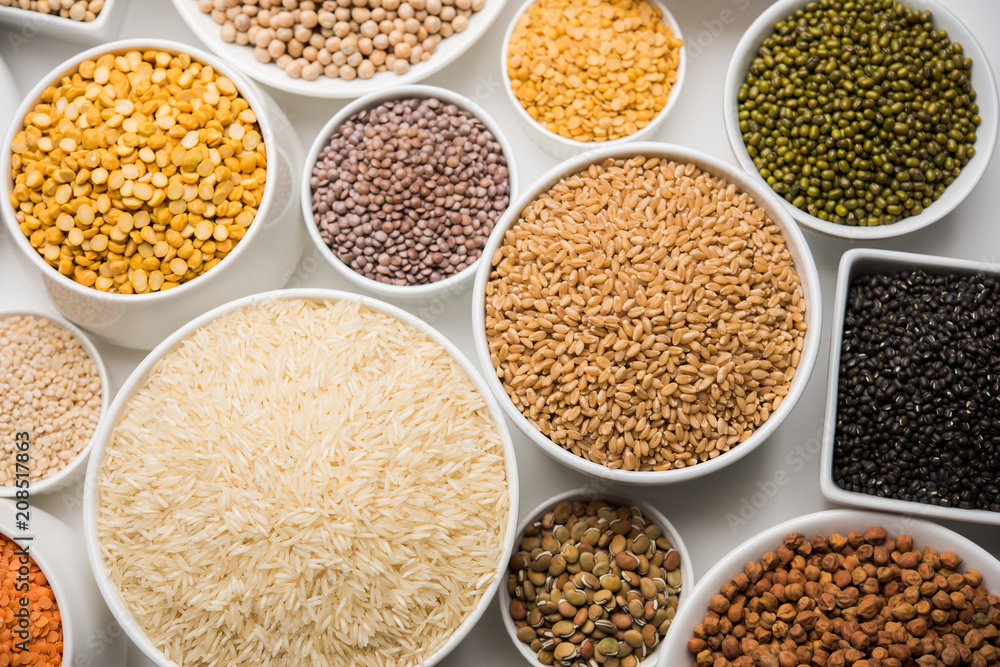 Uncooked pulses,grains and seeds in White bowls over white background. selective focus Uncooked pulses,grains and seeds in White bowls over white background. selective focus