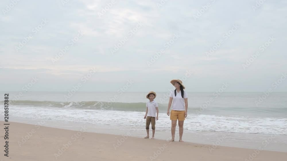 happy family with two kids on the beach, Happy family on sea beach at resort happy family with two kids on the beach, Happy family on sea beach at resort
