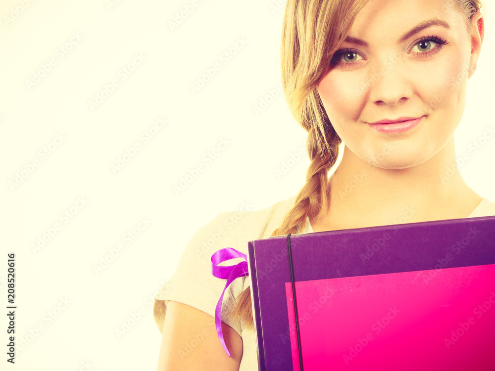 Young teenage student with braid holding books Young teenage student with braid holding books