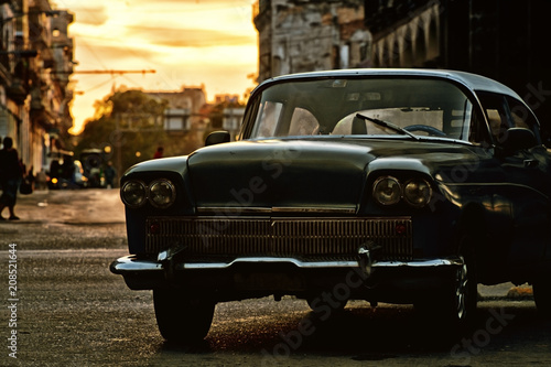 Old classic car in a street of havana, cuba with sunset on background © javier