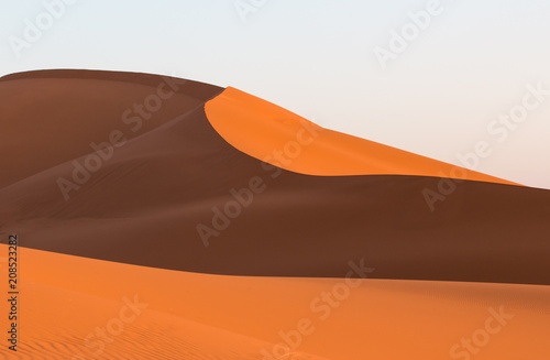 curved waves of dunes in Sahara desert in Morocco