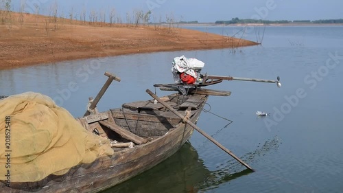 close up simple boat anchor on river bank