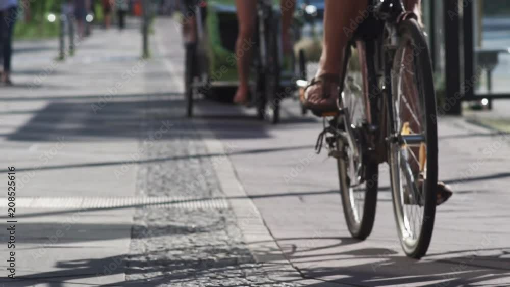 Slow Motion Shot Of Cyclist Traffic On The Bicycle Lane With Two Mothers Riding Bicycles With Baby Trailers. Slow Motion Shot Of Cyclist Traffic On The Bicycle Lane With Two Mothers Riding Bicycles With Baby Trailers.
