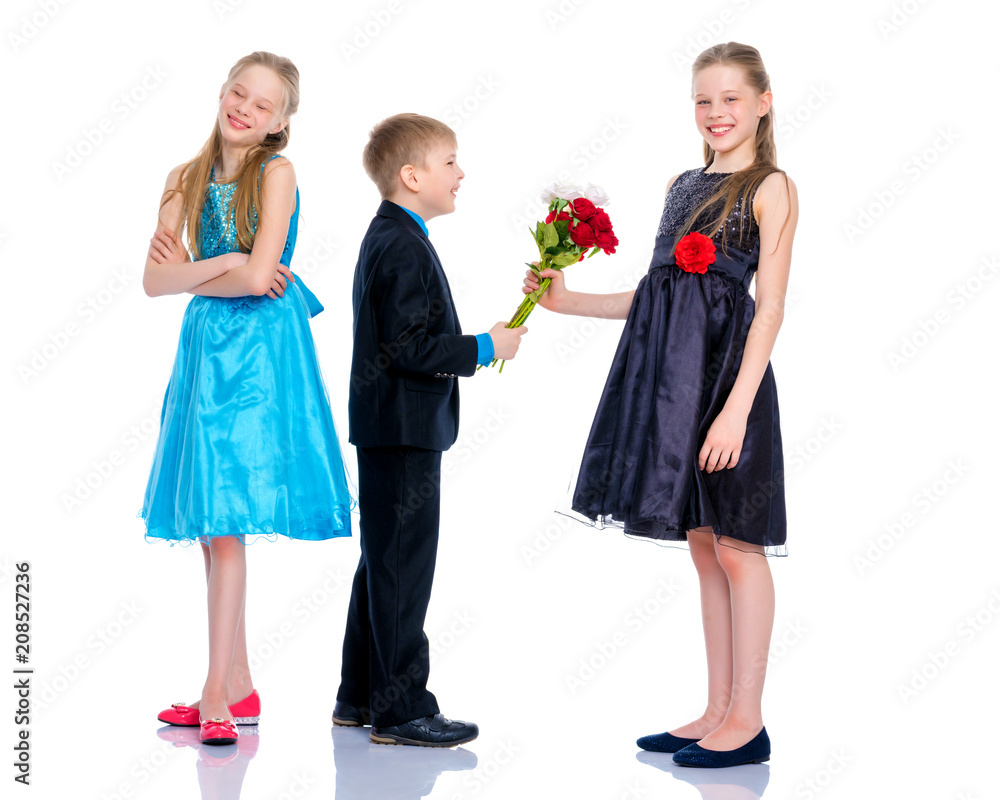 A little boy gives the girl flowers. A little boy gives the girl flowers.