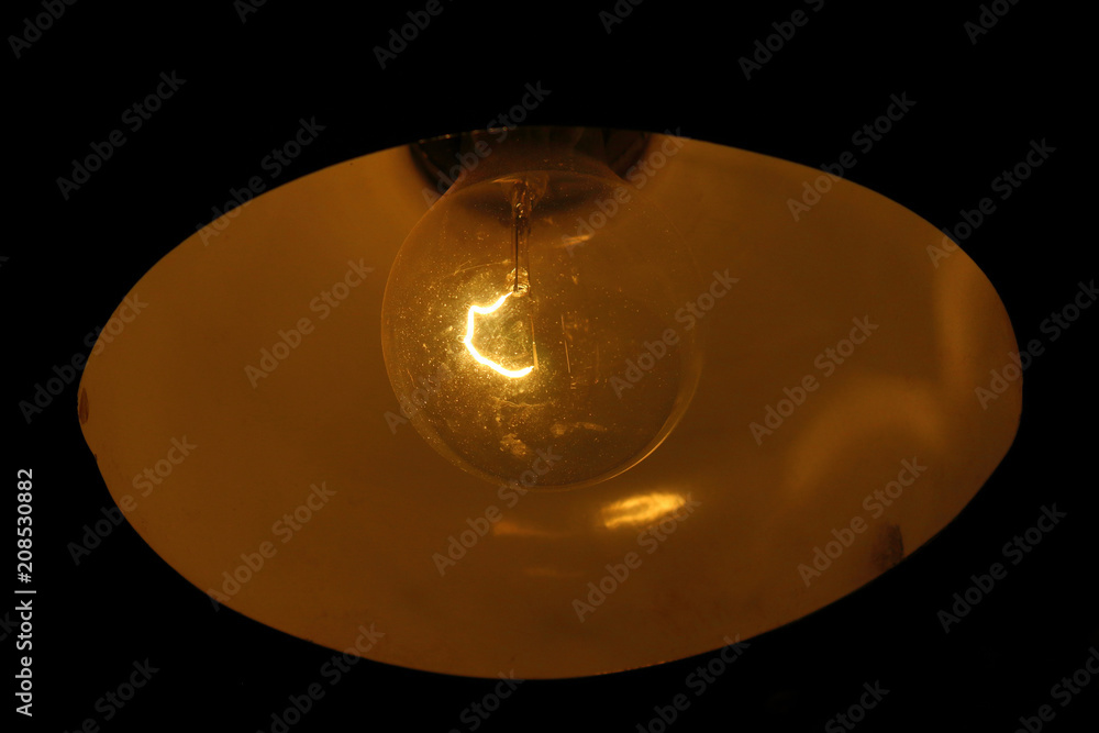 An old dusty light bulb. Incandescent lamp. Close-up. Background. An old dusty light bulb. Incandescent lamp. Close-up. Background.