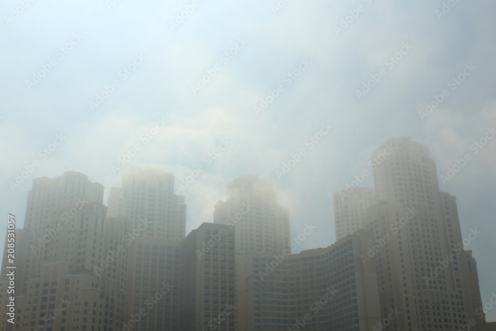 A sandstorm in Dubai. The scorching sun, sand storm and skyscrapers. United Arab Emirates. Background.