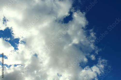 Beautiful natural blue sky and white fluffy clouds. Background. Landscape.