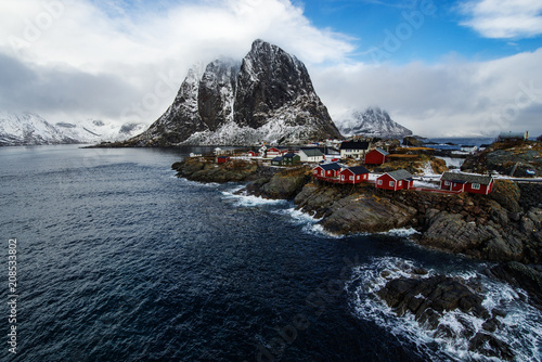Famous tourist attraction Hamnoy fishing village on Lofoten Islands, Norway with red rorbu houses in winter. © FoodAndPhoto