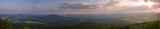 Lusatian Mountains (luzicke hory) wide panorama, panoramic view from Hochwald (Hvozd) mountain on czech german borders with blue green hills forest and pink cloudy sunset sky  background