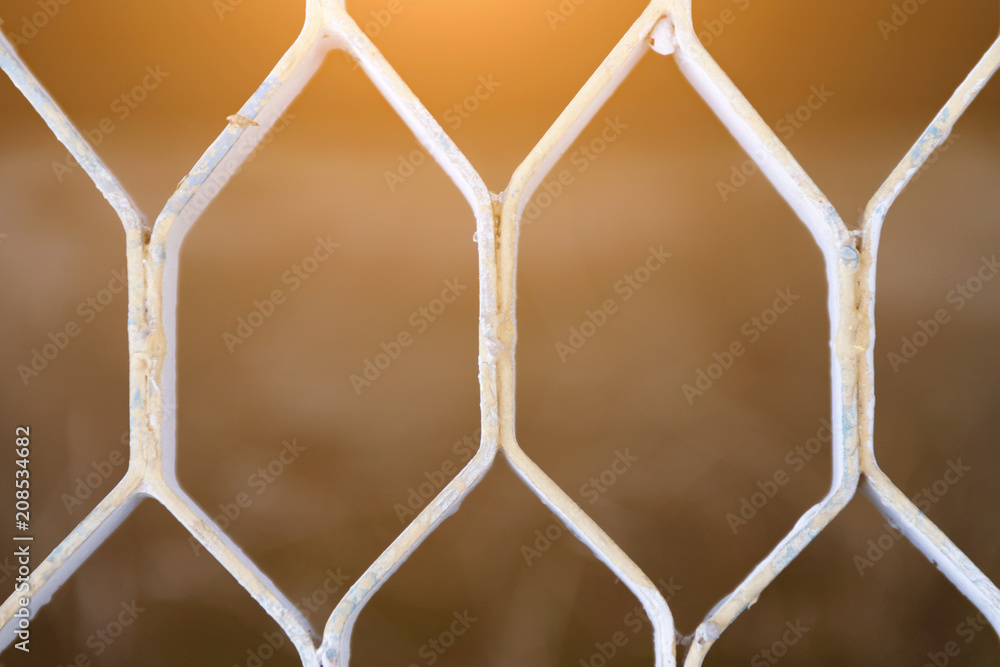 Fototapeta premium The texture of the lattice of the silver floor, the light passes through the lattice, the background of the metal lattice