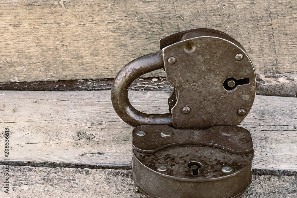 two ancient rusty padlock on a wooden background, toned in sepia-copper two ancient rusty padlock on a wooden background, toned in sepia-copper