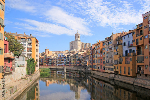 Colorful houses reflected in the water of the river Onyar. Beautiful town of Girona  Catalonia  Spain.