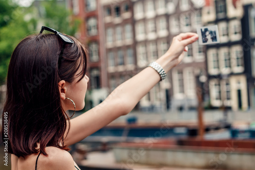 Wall Mural portrait of a beautiful fashionable young girl in the streets of Amsterdam, the