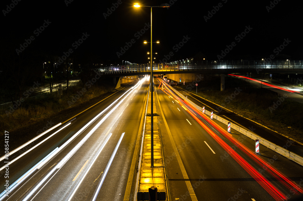 Light trails, city lights and traffic lights on a highway that leads into the city centre of Copenhagen in Denmark. Taken from a bridge near a train station named Ryparken. Light trails, city lights and traffic lights on a highway that leads into the city centre of Copenhagen in Denmark. Taken from a bridge near a train station named Ryparken.