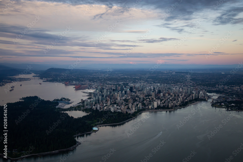 Aerial view of Downtown City during a vibrant cloudy sunset. Taken in Vancouver, British Columbia, Canada.