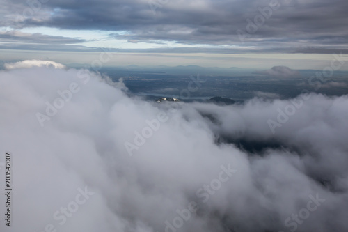 Aerial view of the striking Canadian Mountain Landscape covered in clouds. Taken North of Vancouver, British Columbia, Canada.