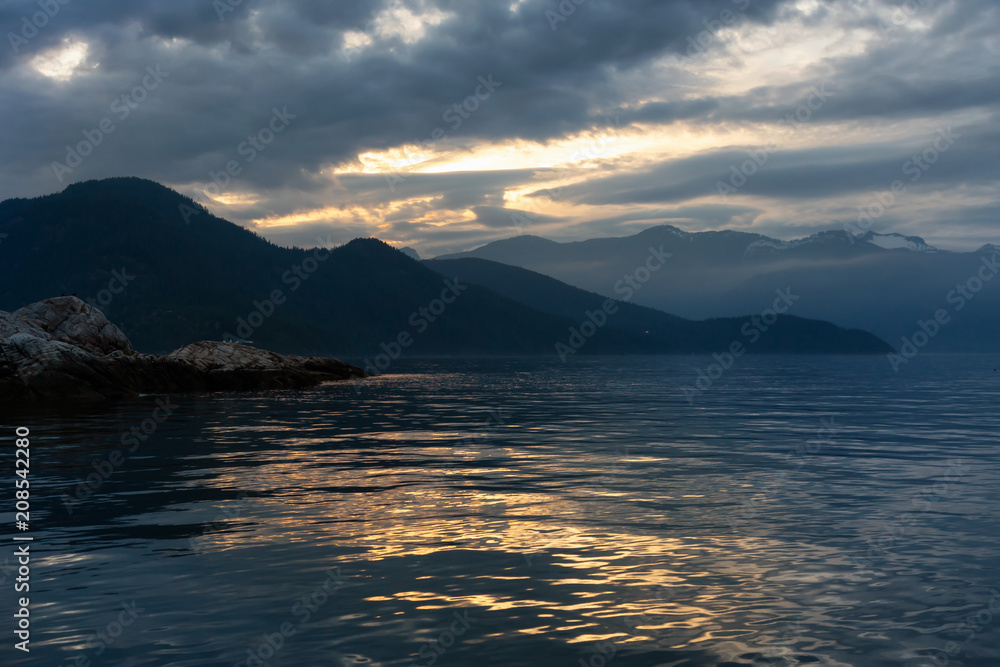 Rocky island with birds during a striking and beautiful sunset. Taken in Howe Sound, North of Vancouver, British Columbia, Canada. Rocky island with birds during a striking and beautiful sunset. Taken in Howe Sound, North of Vancouver, British Columbia, Canada.