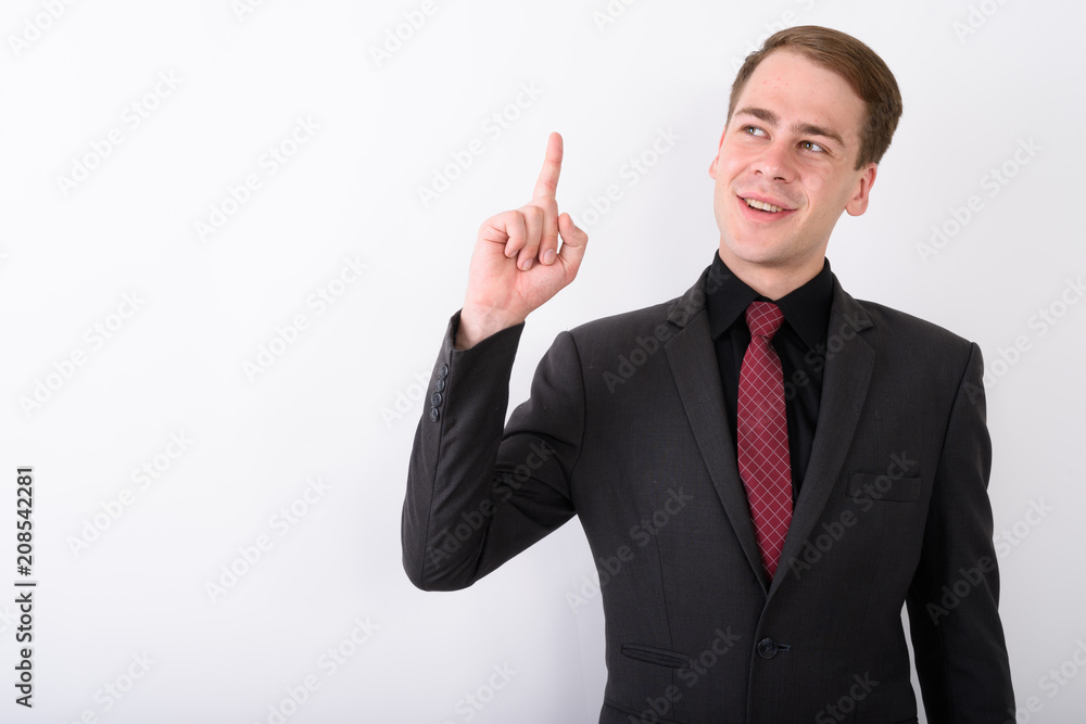 Young handsome businessman wearing suit against white background Young handsome businessman wearing suit against white background