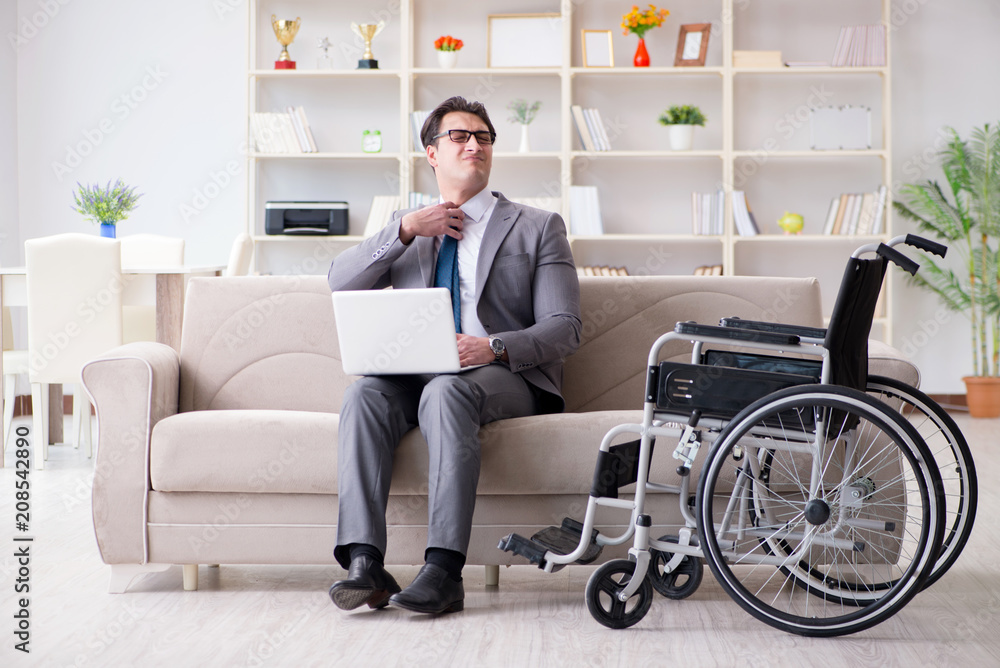 Dsabled businessman on wheelchair working home Dsabled businessman on wheelchair working home