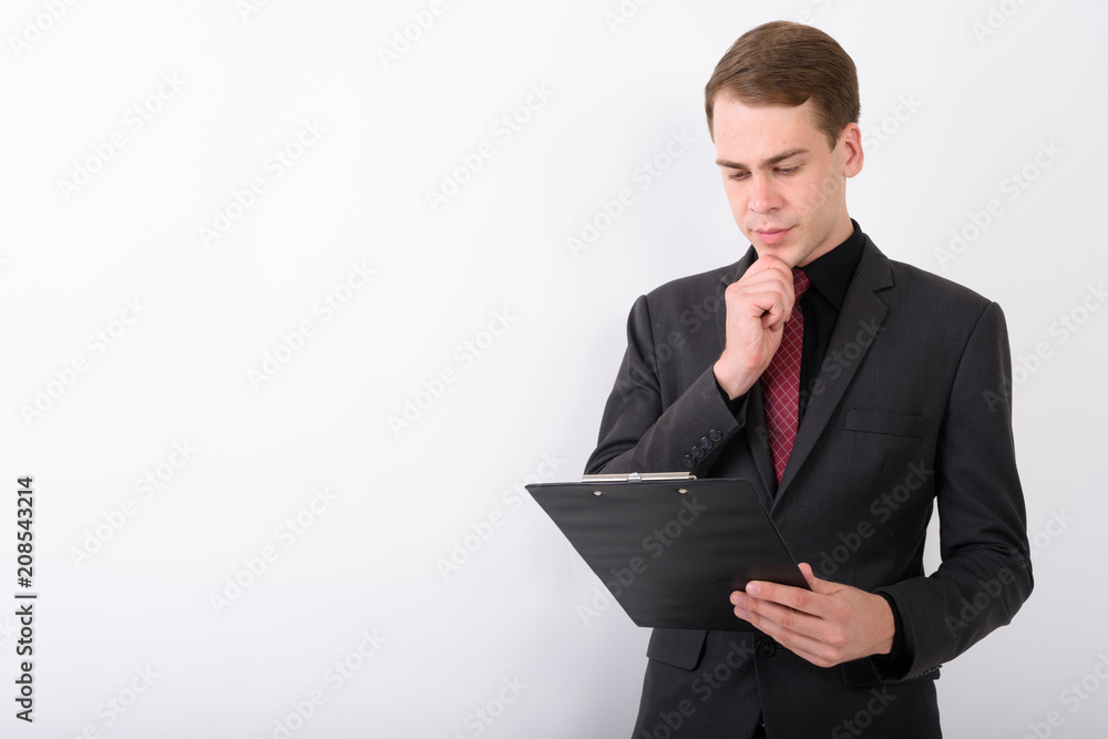 Young handsome businessman wearing suit against white background Young handsome businessman wearing suit against white background