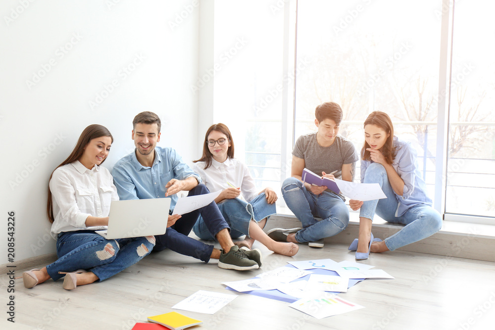 Young team working with marketing plan in office Young team working with marketing plan in office