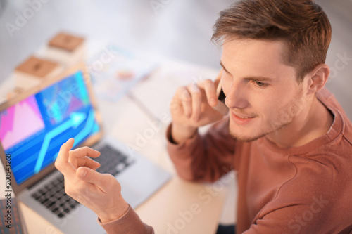 Young man talking on phone ...
