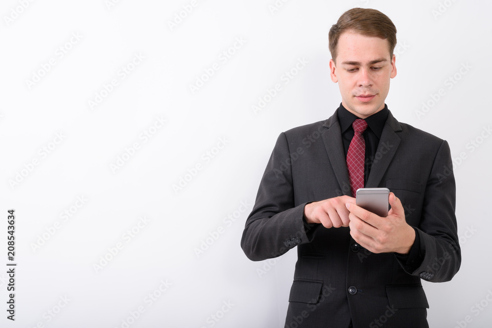 Young handsome businessman wearing suit against white background Young handsome businessman wearing suit against white background