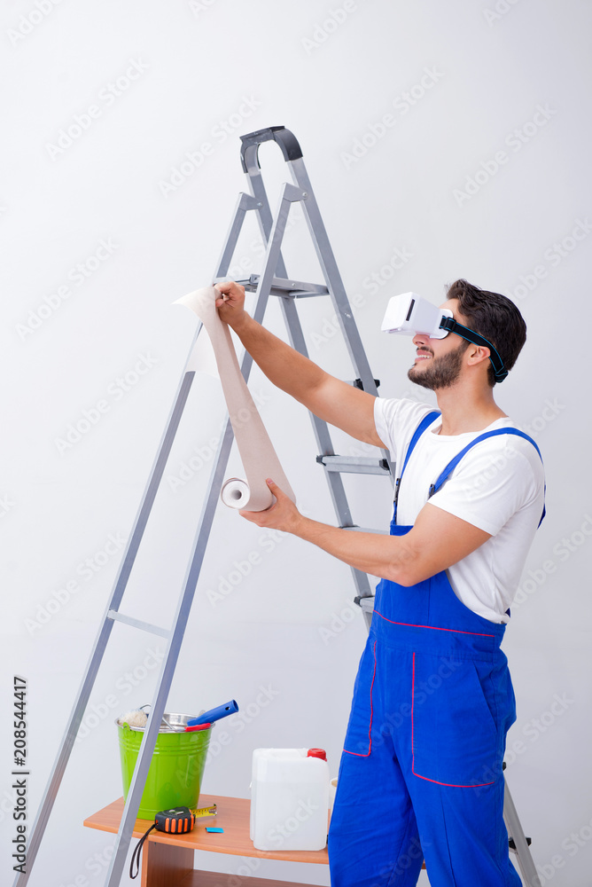 Man with VR glasses gluing wallpaper Man with VR glasses gluing wallpaper