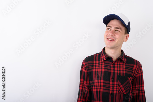 Young handsome man wearing baseball cap and red checkered shirt 