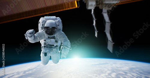 Fototapeta Naklejka Na Ścianę i Meble -  Astronaut working on a space station 3D rendering elements of this image furnished by NASA