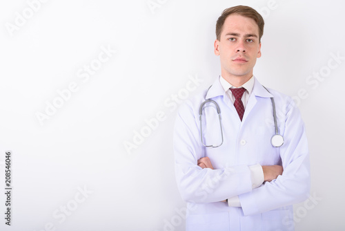 Young handsome man doctor against white background © Ranta Images