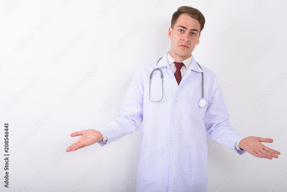 Young handsome man doctor against white background Young handsome man doctor against white background