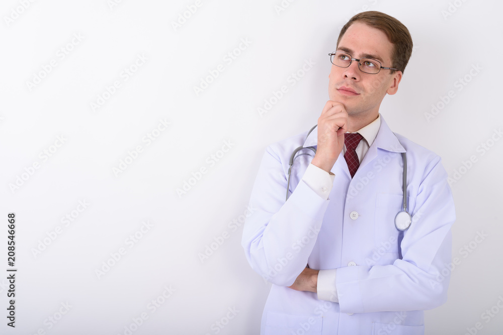 Young handsome man doctor wearing eyeglasses against white backg Young handsome man doctor wearing eyeglasses against white backg