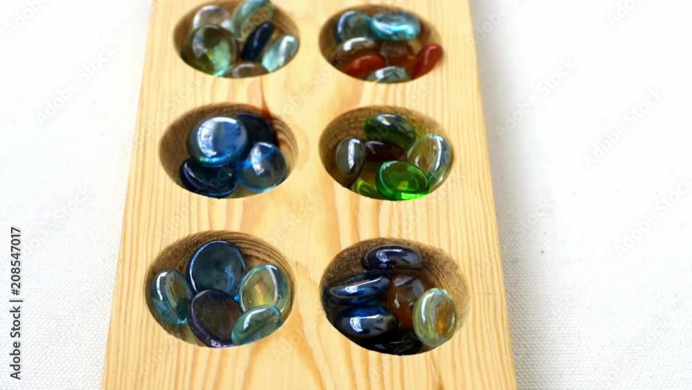 wooden mancala and stones,
wooden mancala and stones,