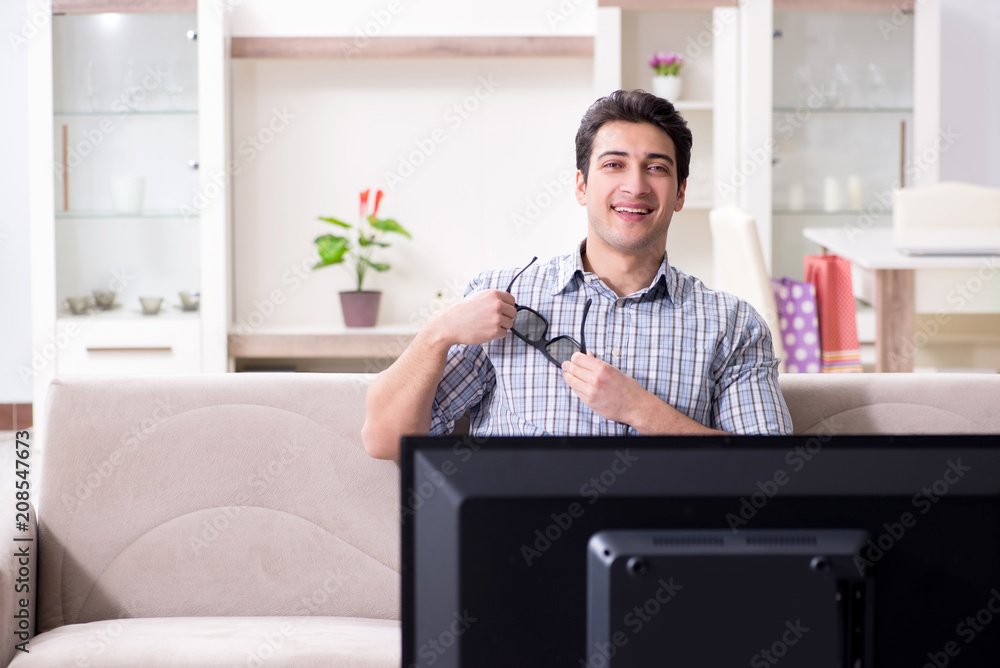 Man watching 3d tv at home