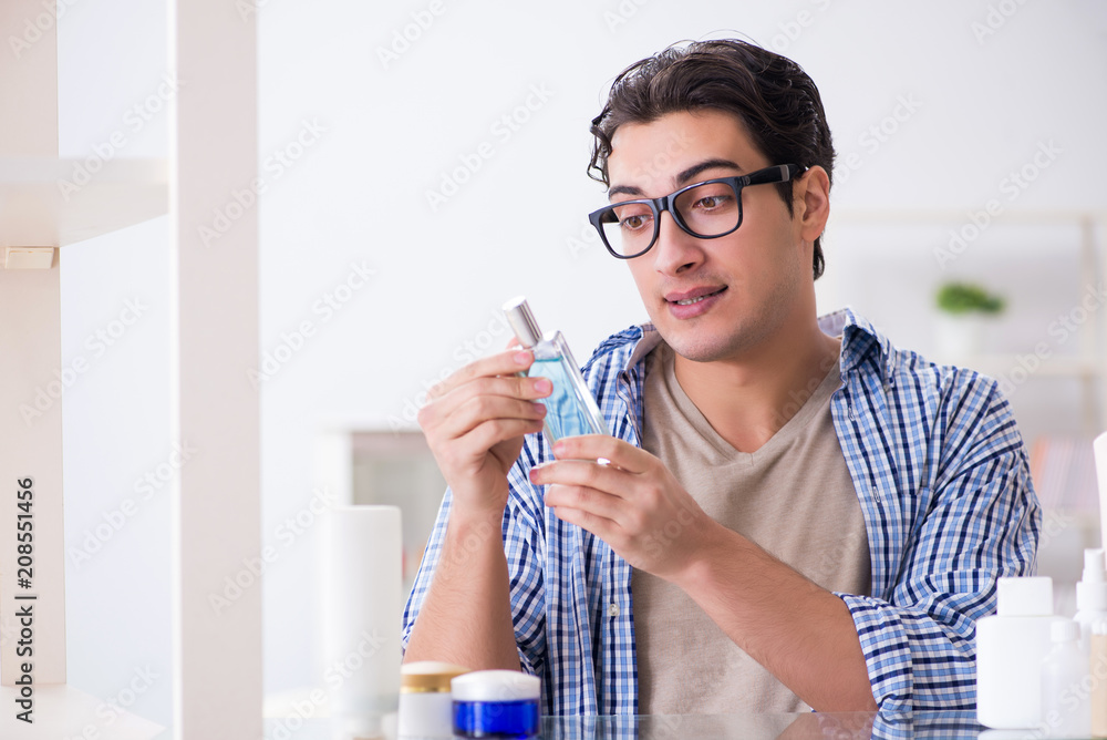 Young man is getting prepared for working day in bathroom Young man is getting prepared for working day in bathroom