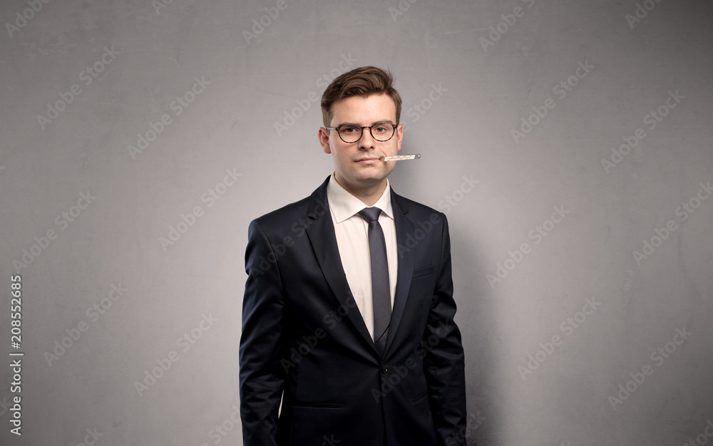 Young tired businessman with thermometer and copy space
Young tired businessman with thermometer and copy space