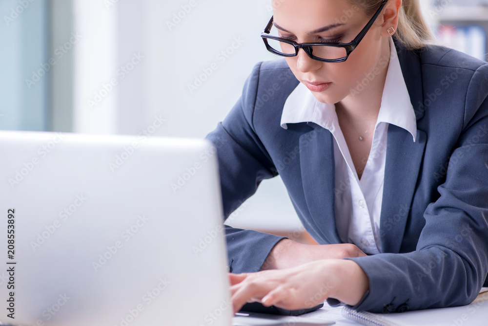 Businesswoman working at her desk in office