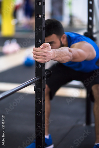 man doing pull ups on the vertical bar