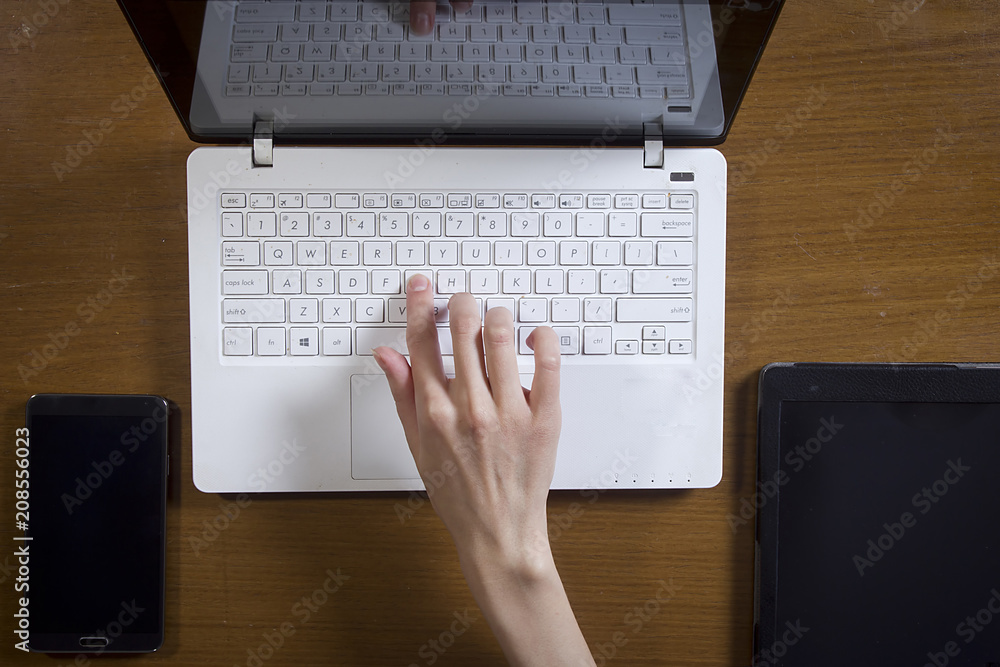 Female hands are working on a laptop computer Female hands are working on a laptop computer