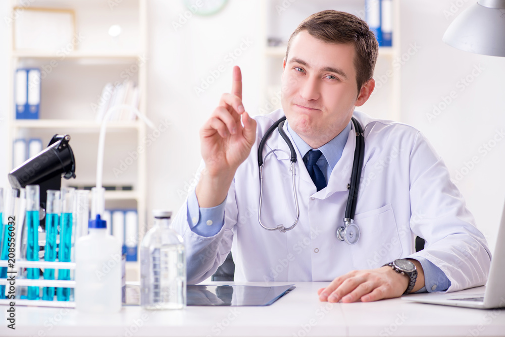 Male doctor looking at lab results in hospital Male doctor looking at lab results in hospital