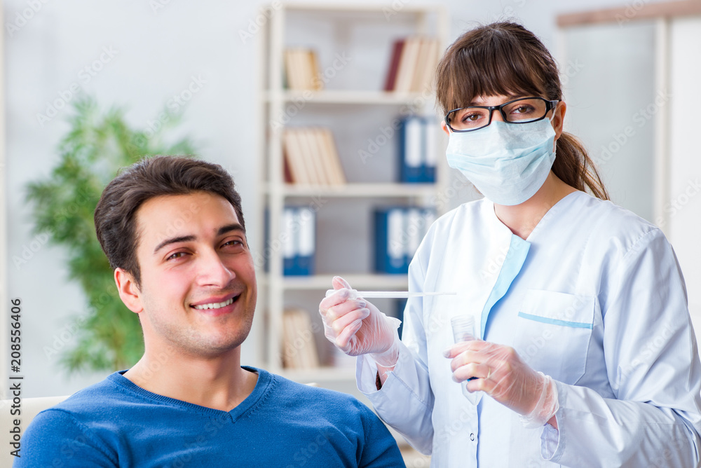 Doctor checking patients ear during medical examination Doctor checking patients ear during medical examination