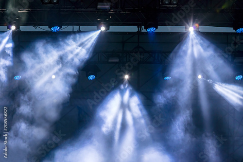 blue rays of light from the stage during outdoor concert 