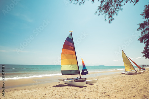 Colorful sailboat on tropical beach in summer. vintage coor effect.