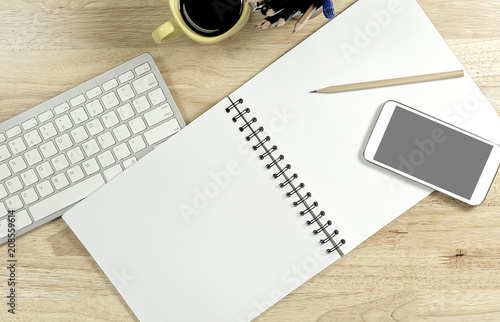 Blank white paper and smart phone with black screen and the cup of coffee and office supply for working business communication concept.