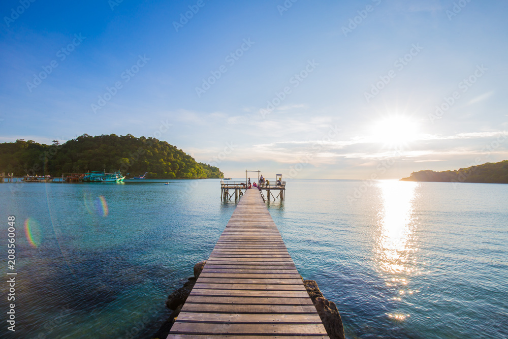 Tropical seascape with wooden bridge to the sea sunset sky cloud