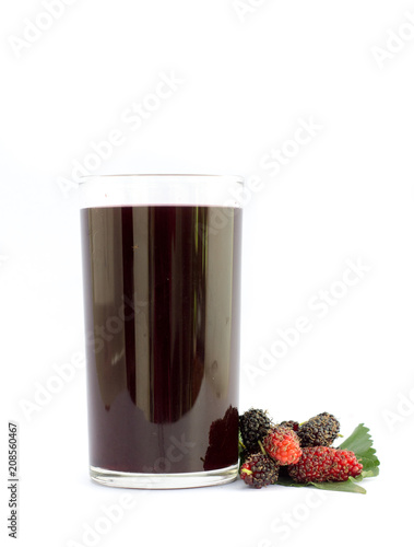 Mulberry juice in glass with ripe mulberry fruits on white isolated