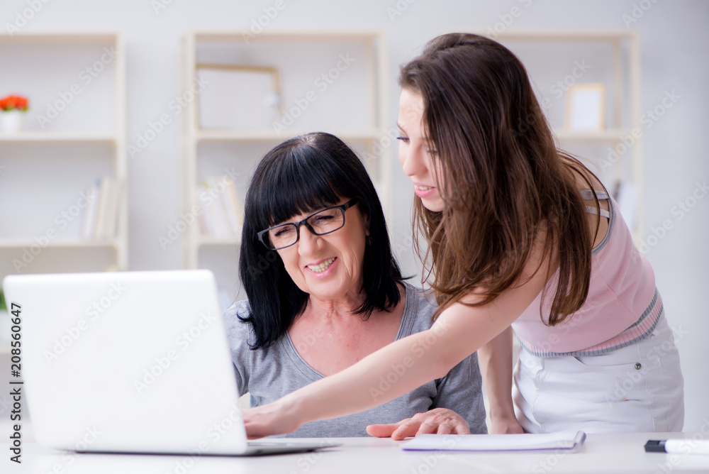 Daughter explaining to mom how to use computer Daughter explaining to mom how to use computer