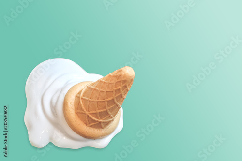 Ice cream cone fallen on blue vintage background.