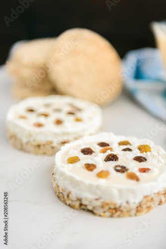 Homemade healthy sandwiches. Crisp bread with cottage cheese, baked milk and raisins on light background.
